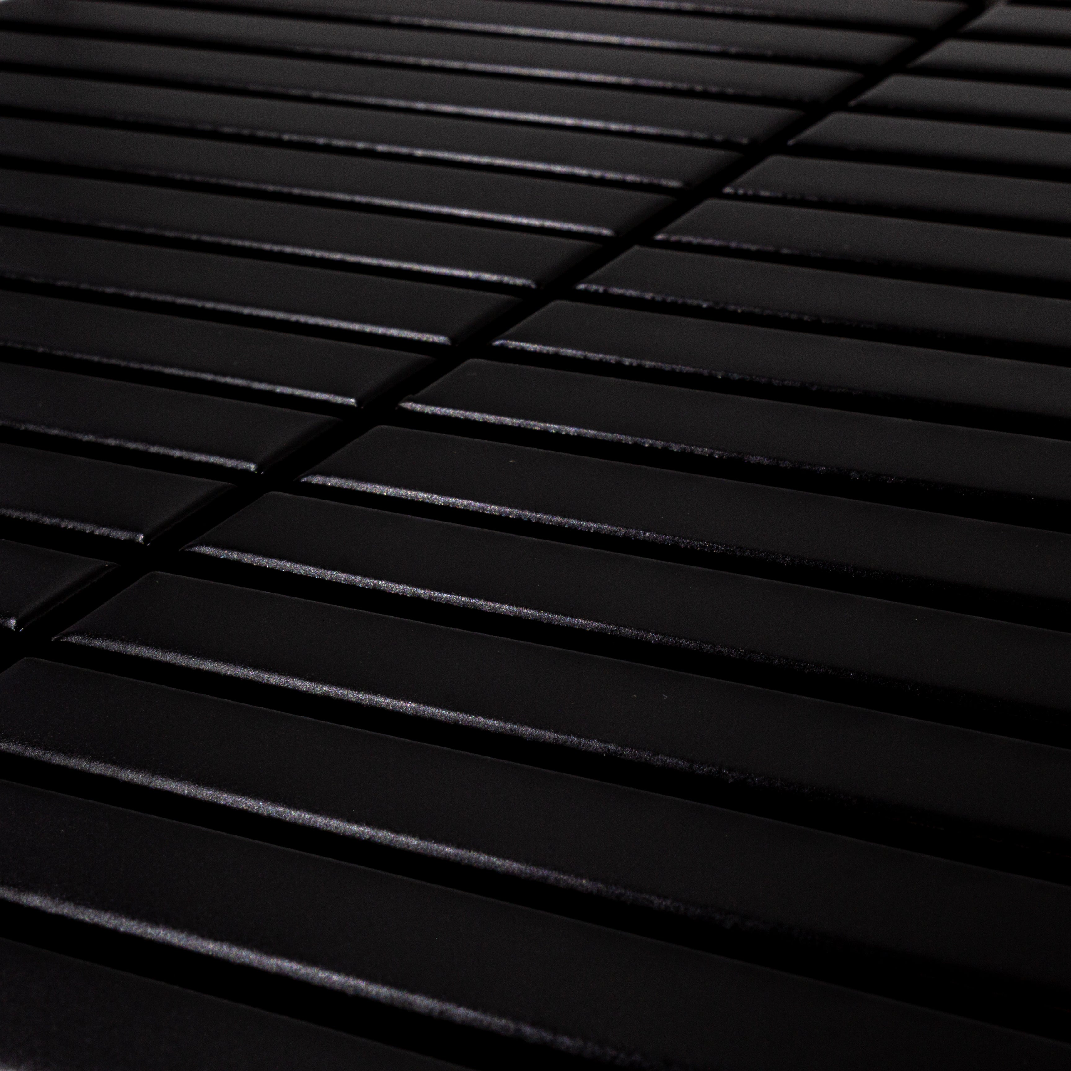 Angled close up view of a single sheet of kitkat stacked mosaic tiles in matte true black. The sizing is 5/8' x 5-5/8