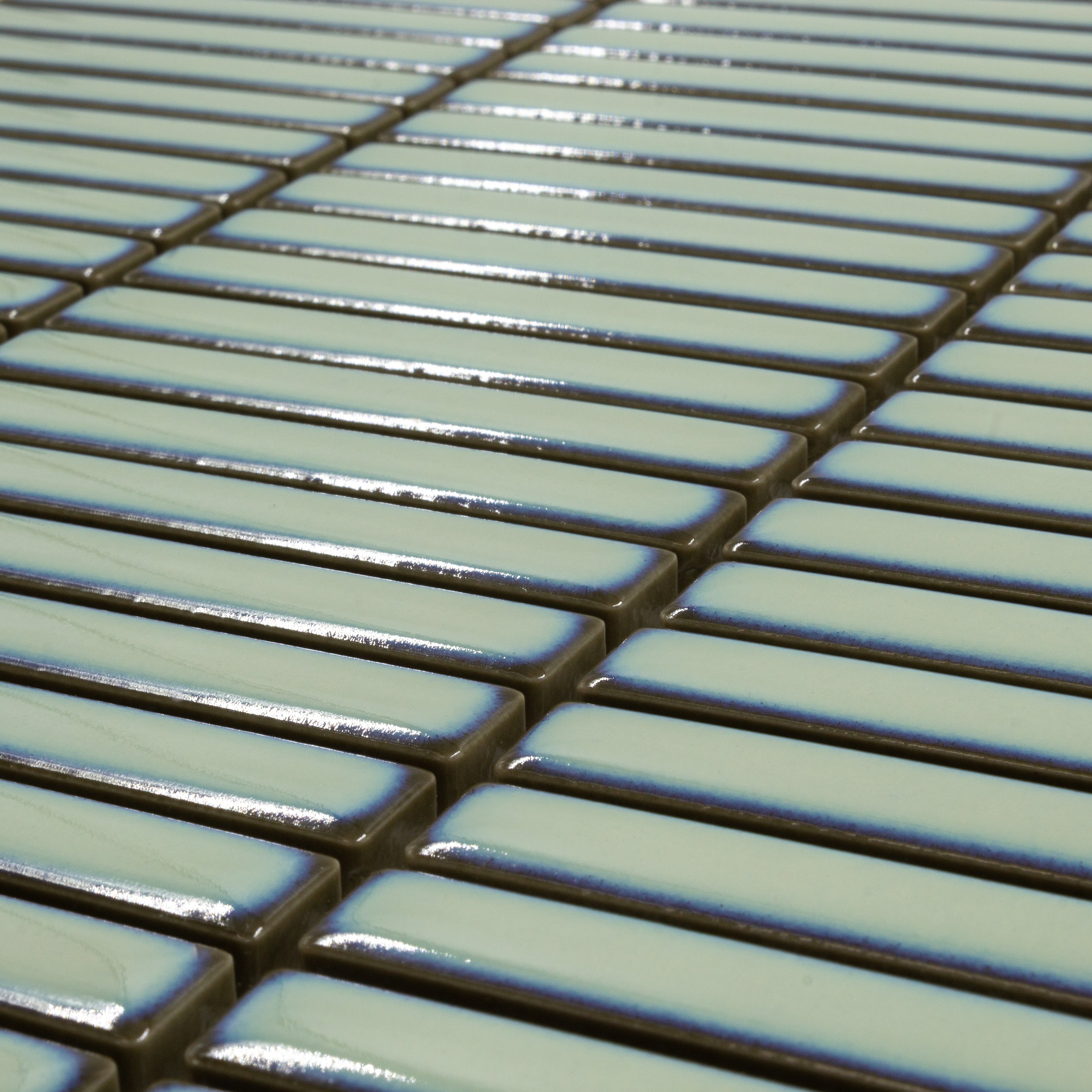 Angled close up view of a single sheet of mini kitkat stacked mosaic tiles in aqua green glossy. The sizing is 3/8' x 3-5/8