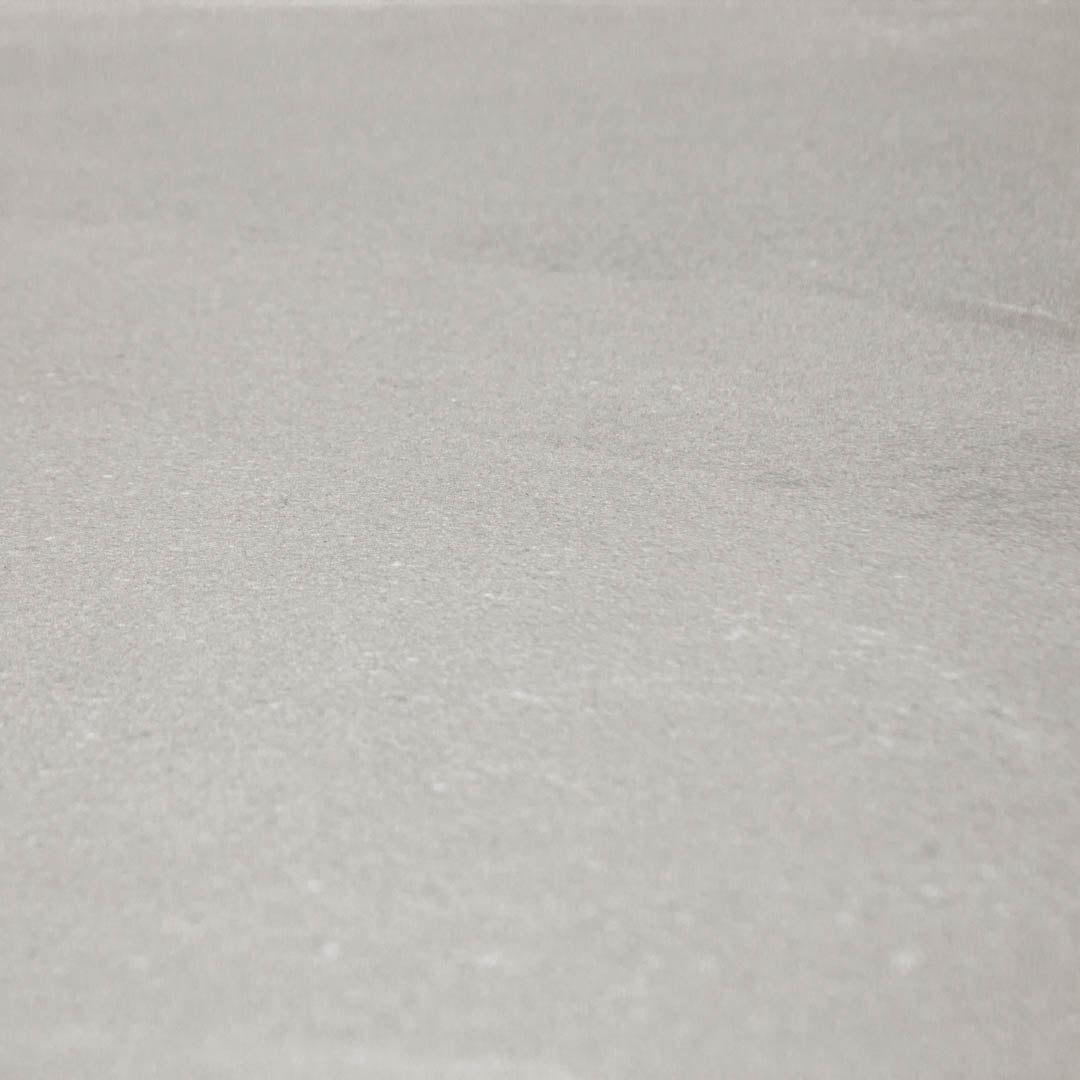 Angled close up of 24x48 limestone look tiles in taupe to highlight the finish and pattern