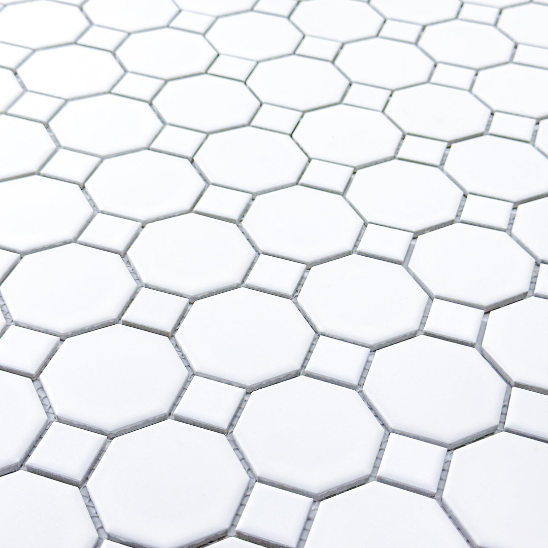 Close up angled view of a single sheet of Octa-Dot White, a classic timeless geometric pattern white octagon and dot penny mosaic tile. 