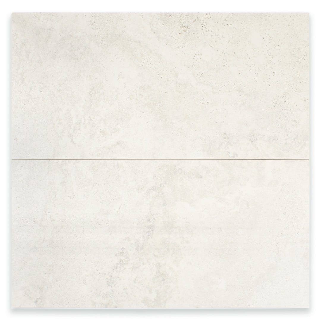 Ariel view of two large rectangular 12x24 tile that resembles travertine stone in light grey white. 